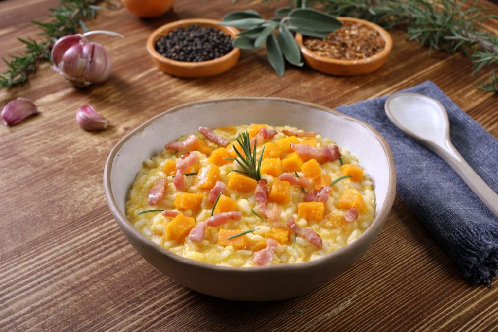 zuppiera con risotto zucca e pancetta, tovagliolo e cucchiaio